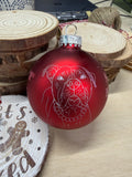 red round glass ornament with a pit bull in white
