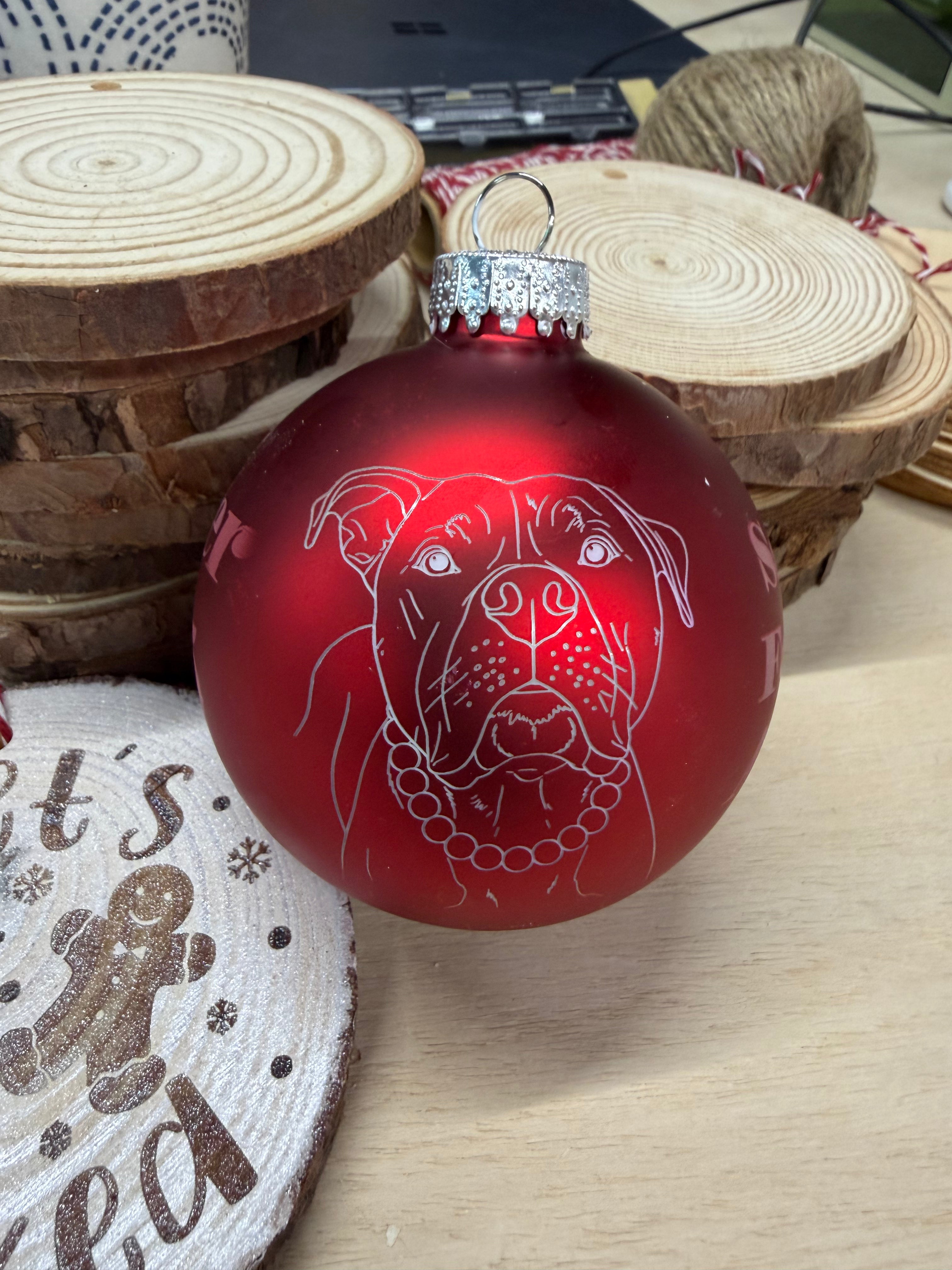 red round glass ornament with a pit bull in white