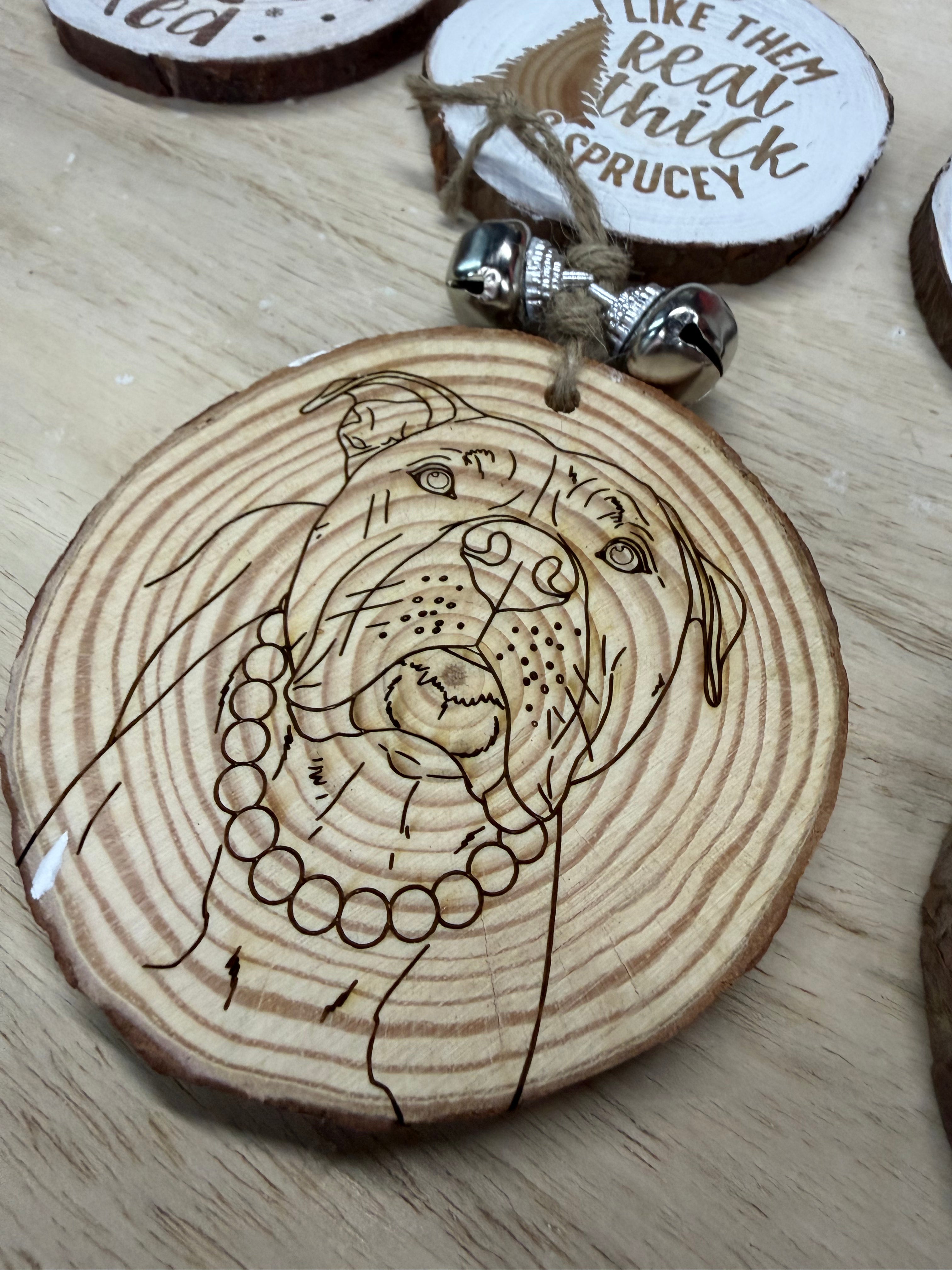 wooden round with a pit bull