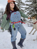 woman wearng biothane training belt with poop bag holder attached